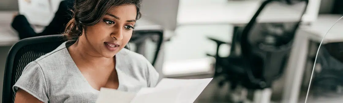 Woman working with immigration documents at desk