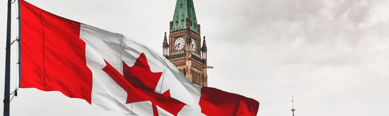 Canadian flag flying over skyline near Peace Tower